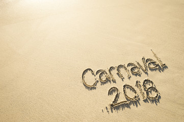 Fototapeta na wymiar Message for Carnaval 2018 written on smooth sand beach