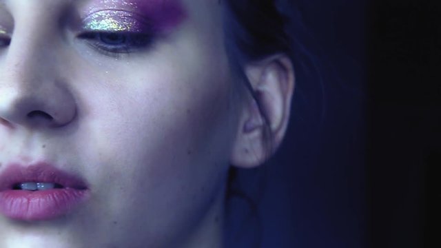 Use makeup on a beautiful woman. Slow motion