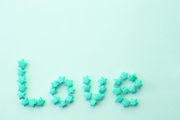 word "love" written by means of small paper stars