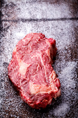 Raw Fresh Marbled Meat Beef Steak on the Gray Metal Background  Top View Copy space for Text