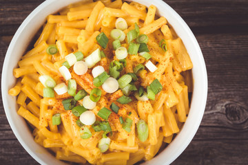 cheddar mac and cheese bowl over rustic wooden table