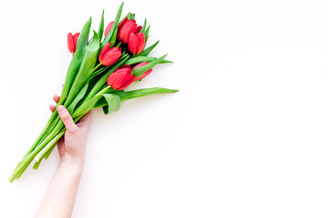 Bright red tulips for spring bouquet on white background top view copy space