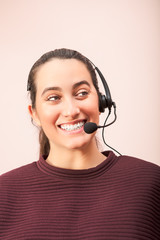 Smiling woman using headset in call center