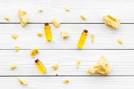 Scattered cocoa butter pieces and cococa grains. Cosmetics with natural ingredient. White background top view