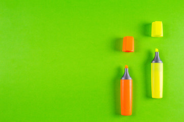 Markers highlighter pens on greenery background