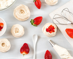 A small meringue Pavlova dessert with some strawberry slices . Top view. pattern