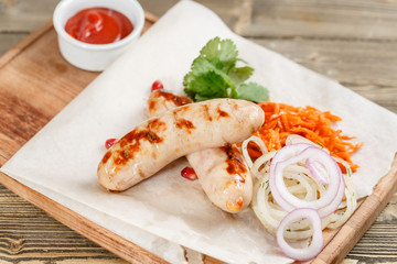 grilled sausages. Serving on a wooden Board on a rustic table. Barbecue restaurant menu, a series of photos of different meats
