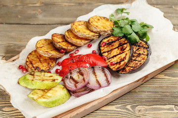 grilled vegetables. Serving on a wooden Board on a rustic table. Barbecue restaurant menu, a series of photos of different dishes