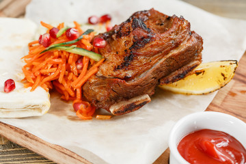 grilled beef ribs. Serving on a wooden Board on a rustic table. Barbecue restaurant menu, a series of photos of different meats