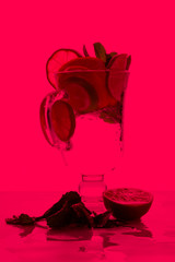 Mojito with lime and lemon and mint, cocktail with ice in a glass cup, soft drink with ice on a light background, empty space, cocktail pop art, toned background, summer drink