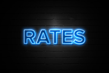 Rates neon Sign on brickwall
