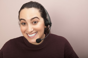 Smiling woman with headset in call center