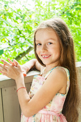 Beautiful little girl in summer background