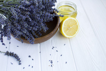 Dry lavender,lemon and honey on the white  wooden background