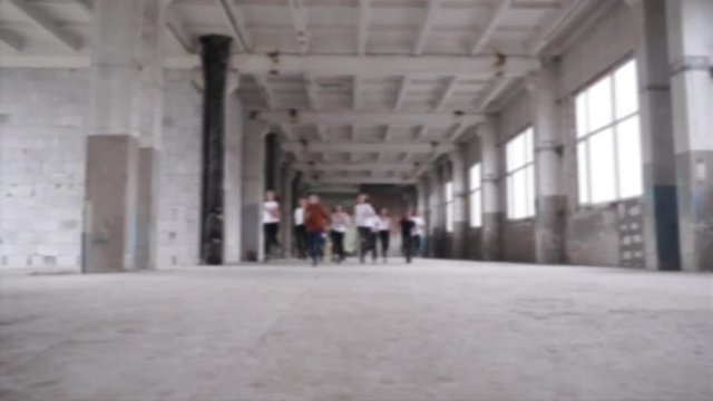 A frightened group of teenagers run in the building. Creative abstract blur background with bokeh effect
