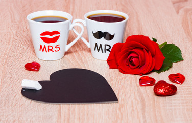 Valentines Day background with two coffee cups, hearts, chalkboard and rose flower