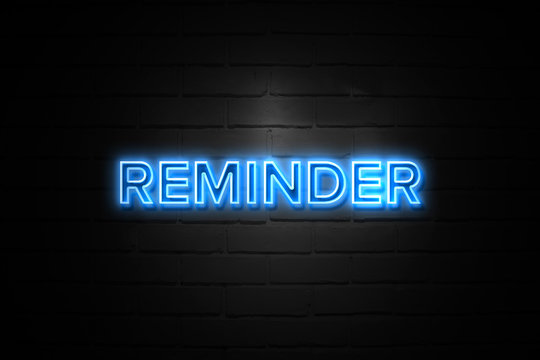 Reminder neon Sign on brickwall