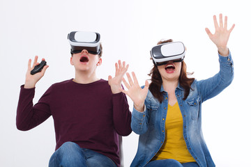 Young man and woman in casual clothes in virtual goggles, vr isolated on white background. Technology and innovation concept. Copy space and mock up. Template