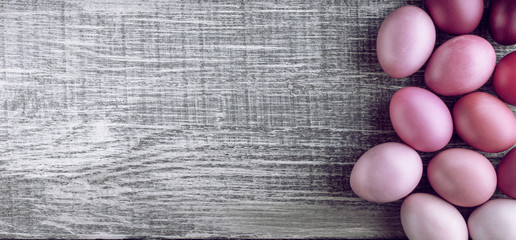 Easter eggs in fashionable colors on a gray wooden background