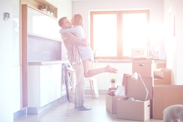 Portrait of young couple moving in new home. Young couple