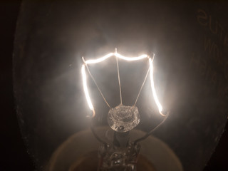 close up of bright white light bulb filament macro