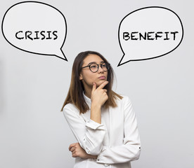 Young pretty asian woman thinking about hard choice between crisis and benefit. Businesswoman concept. Selective focus and shallow DOF