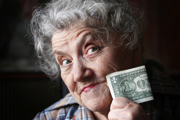 Elderly woman with dollar