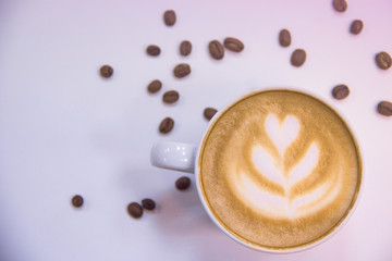 coffee with heart pattern on foam and coffee beans