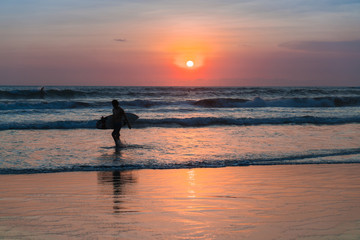 Beach with people in sunset