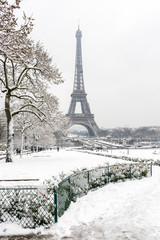 Winter in Paris in the snow. The Eiffel tower seen from the Trocadero garden covered with snow.