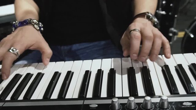Musician plays on classical piano keys on the concert show