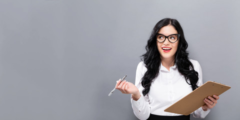 Office woman with a clipboard on a solid background