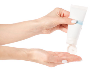 White tube of cream in hand