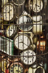 Old antique retro clocks in iron cage. Collection of vintage