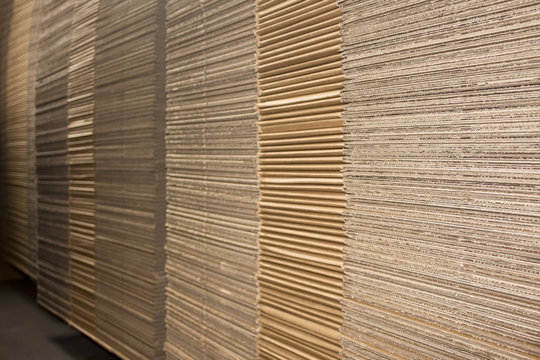 Stack of flat industrial folding cardboard packaging boxes