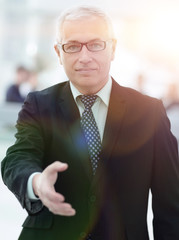 closeup of a senior businessman offering his hand for greeting.