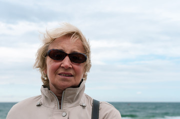 Portrait of senior woman with sunglasses at the beach of Sylt