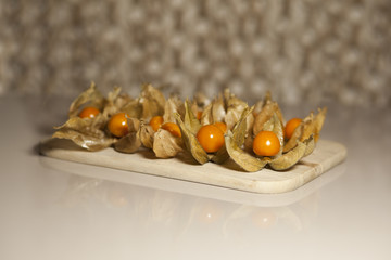 Ground cherry husk tomato chinese lantern on a wooden board