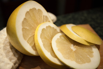 Yellow pomelo on wooden cutting board, healthy food