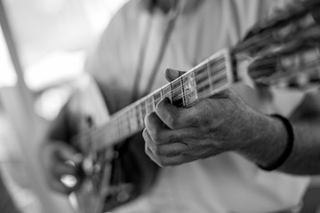 Close up of man hand playing bouzouki