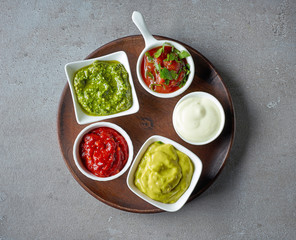 various sauces on grey table