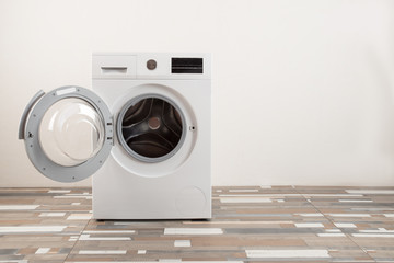 Parents bought a new washing machine. The children try to turn it on and wash the soft toys. Happy boys are playing at home.