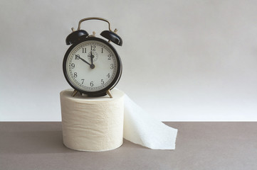 Alarm clock with toilet paper.