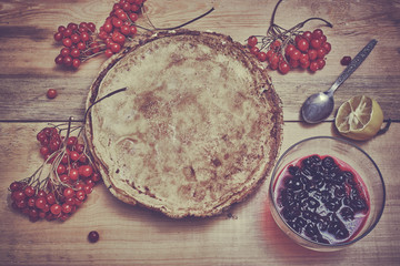 Fototapeta na wymiar Delicious pancakes and jam decorated with viburnum