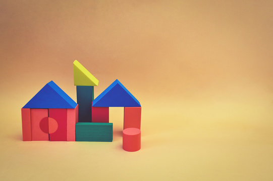 House Made From Wooden Toy Blocks On Yellow Background