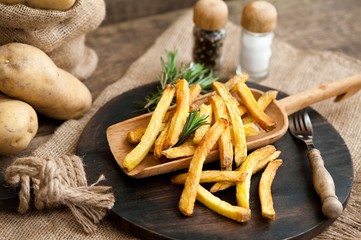 Fast food french fries potatoes with skin served with salt and herbs