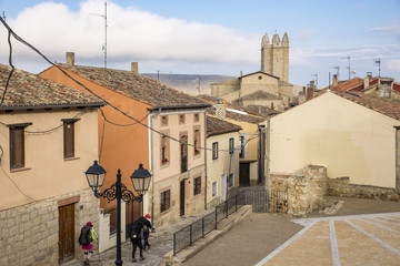 Fototapeta na wymiar pilgrims walking a street in Castrojeriz town, province of Burgos, Spain