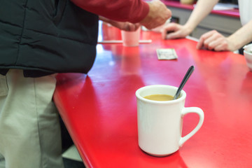 Cup of coffee on a bar table.