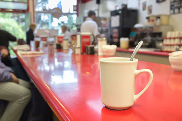 Cup of coffee on a bar table.