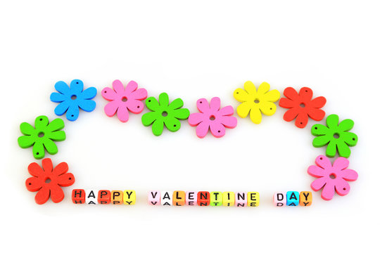 Valentines day concept and holidays, Colorful of artificial flowers and text  " HAPPY VALENTINE DAY " in the small cube, isolated on white background.